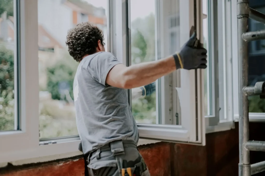Technician installing double hung window